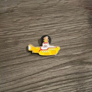 The Beatles yellow submarine enamel pin.